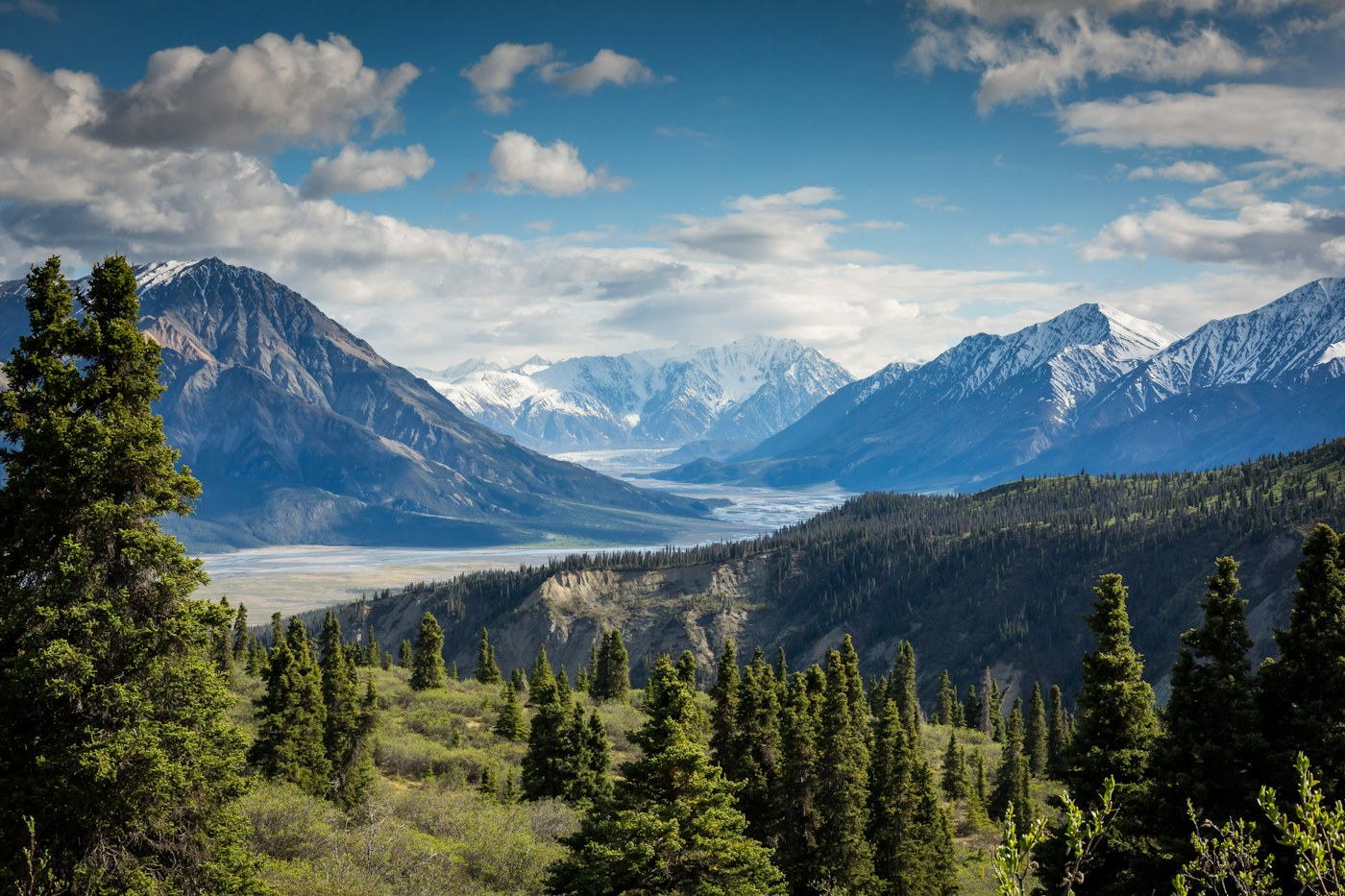 Mountain peaks and a green valley under a cloudy sky