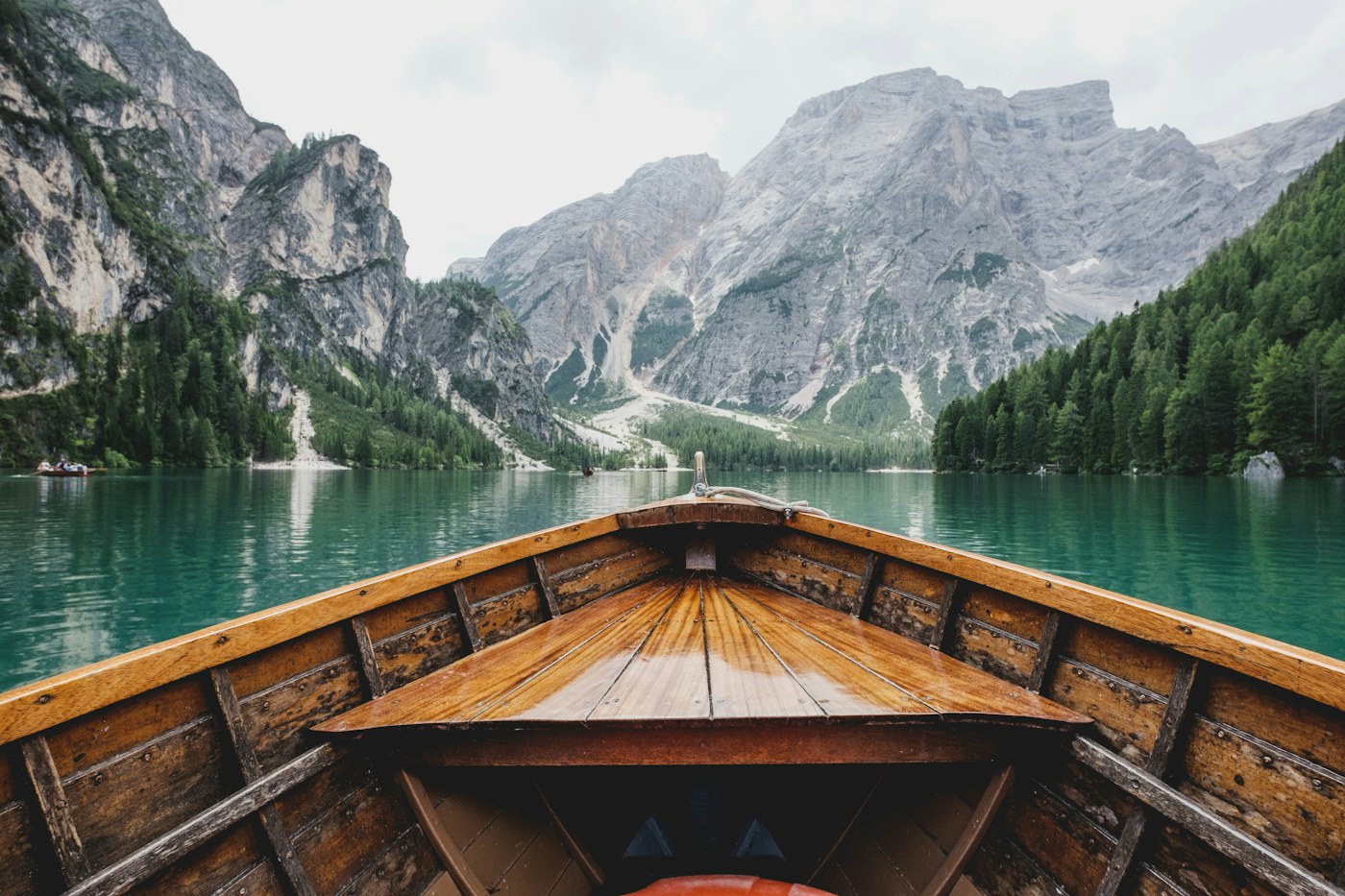 A wooden boat beside a mountain lake