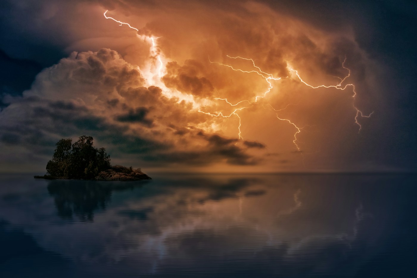 Lightning illuminating storm clouds above the sea