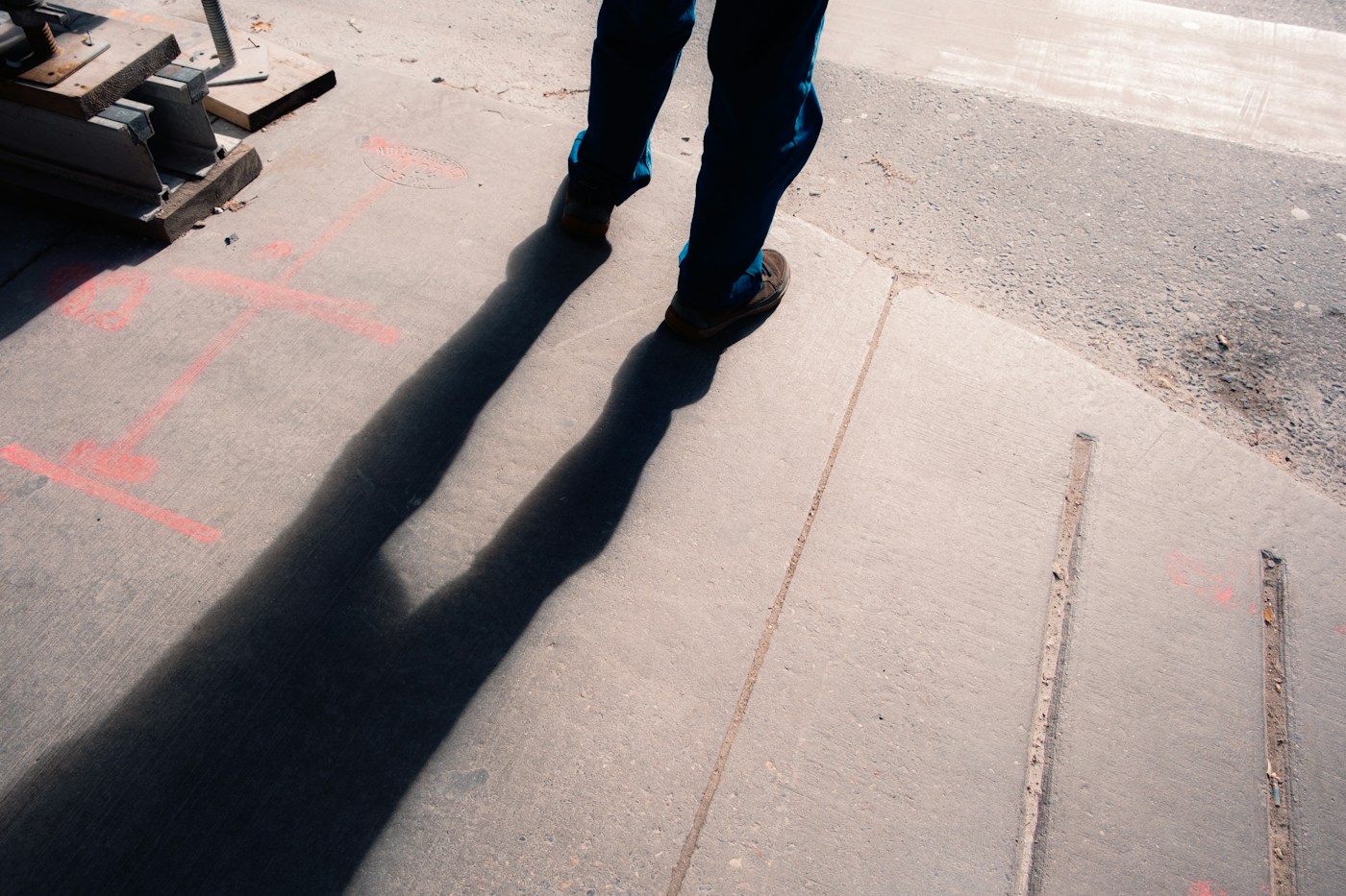 A person’s long shadow on a pavement